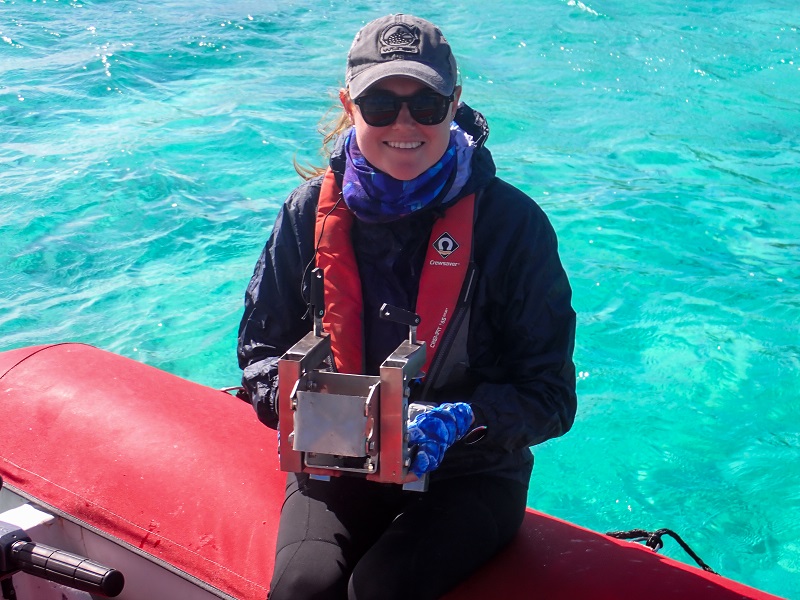 girl sits in a tender holding technical gear
