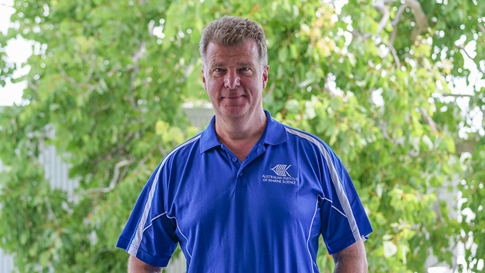 Man stands infront of trees