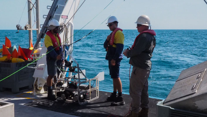 Man stand on the back of a vessel ready to deploy a vessel