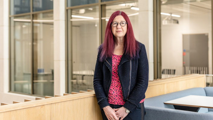 Woman stands in a corporate building