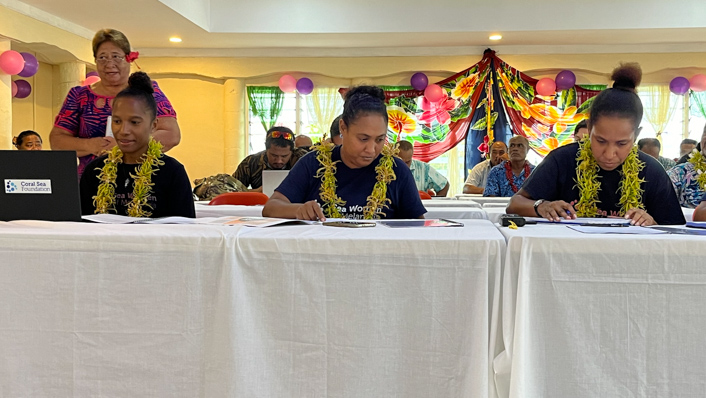 people behind laptops dressed in traditional clothing
