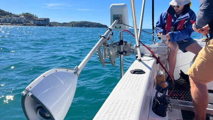 Engineers testing robotics hardware on a boat