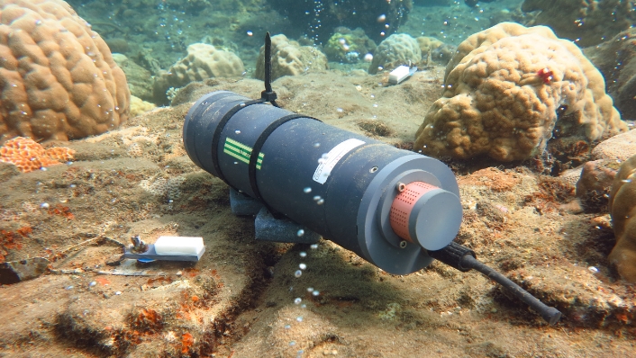 Cylindrical scientific instrument on sea floor