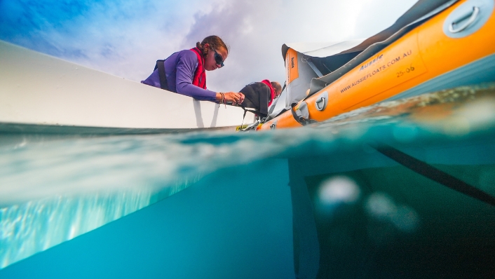 Scientists collecting samples from boat in tropical seas