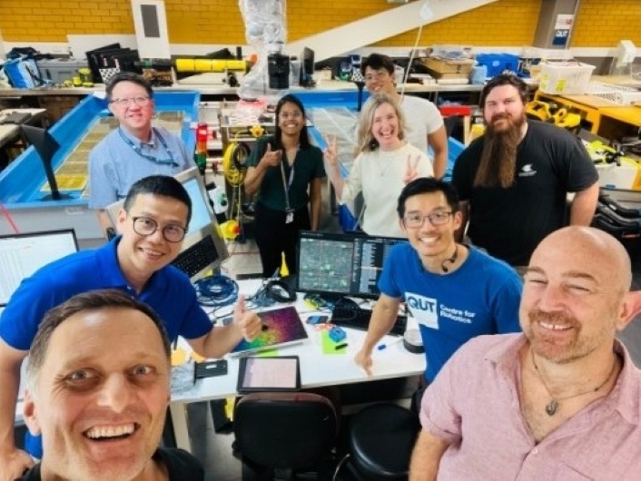 Team selfie with scientists and engineers in a workshop