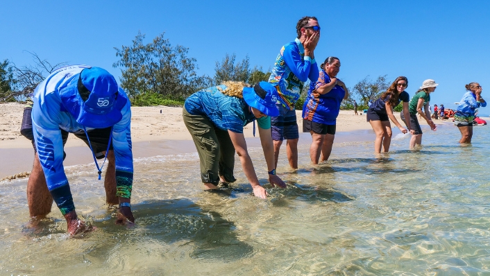 Indigenous water ceremony on a tropical Australian beach