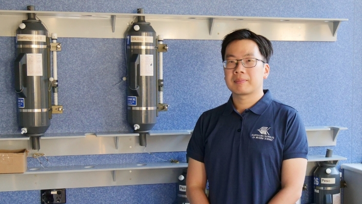 Scientist in front of niskin bottles