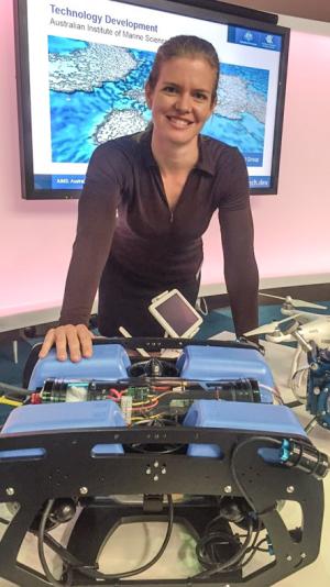 person with underwater drone in front of a tv screen