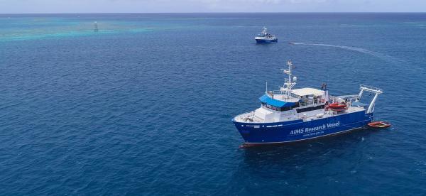 two research vessels a distance apart on the ocean
