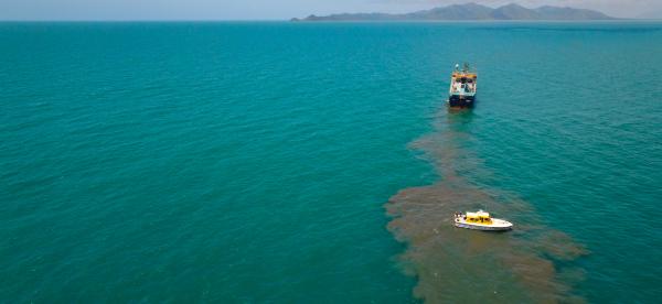aerial view of a bay with a dredge next to a plume