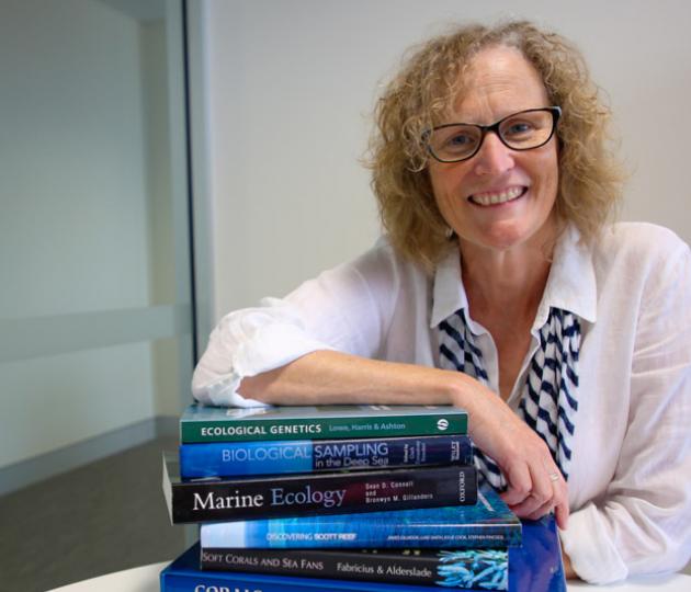 Portrait photo of scientist with glasses and science texts