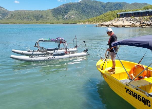 Autonomous surface vessel on water with Mt Cleveland behind