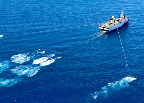 A ship tows research equipment