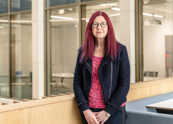 Woman stands in a corporate building
