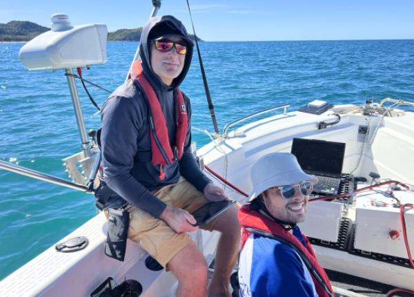 Engineers on a boat testing robotics hardware