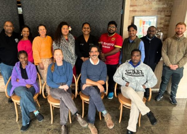 People posing for photo in classroom