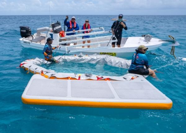Scientists setting up inflatable pool in tropical seas