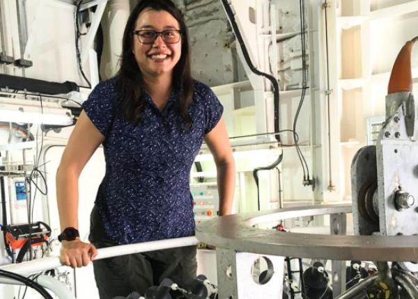 Oceanographer Dr Jessica Benthuysen on a research vessel next to ocean measuring equipment
