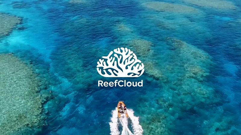 Aerial view of reef with small boat and ReefCloud brand