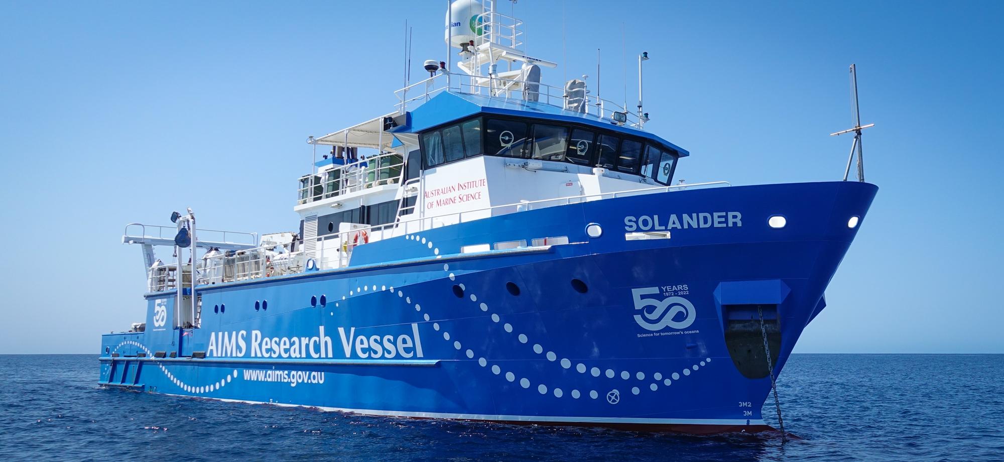 blue and white AIMS vessel with 50th anniversary logo on hull