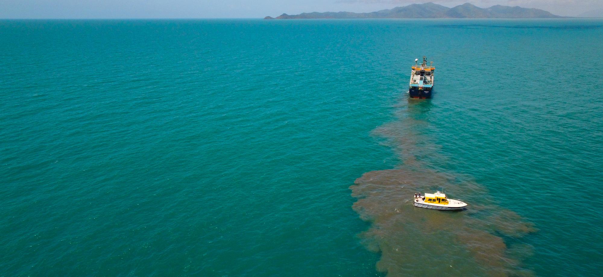 aerial view of a bay with a dredge next to a plume