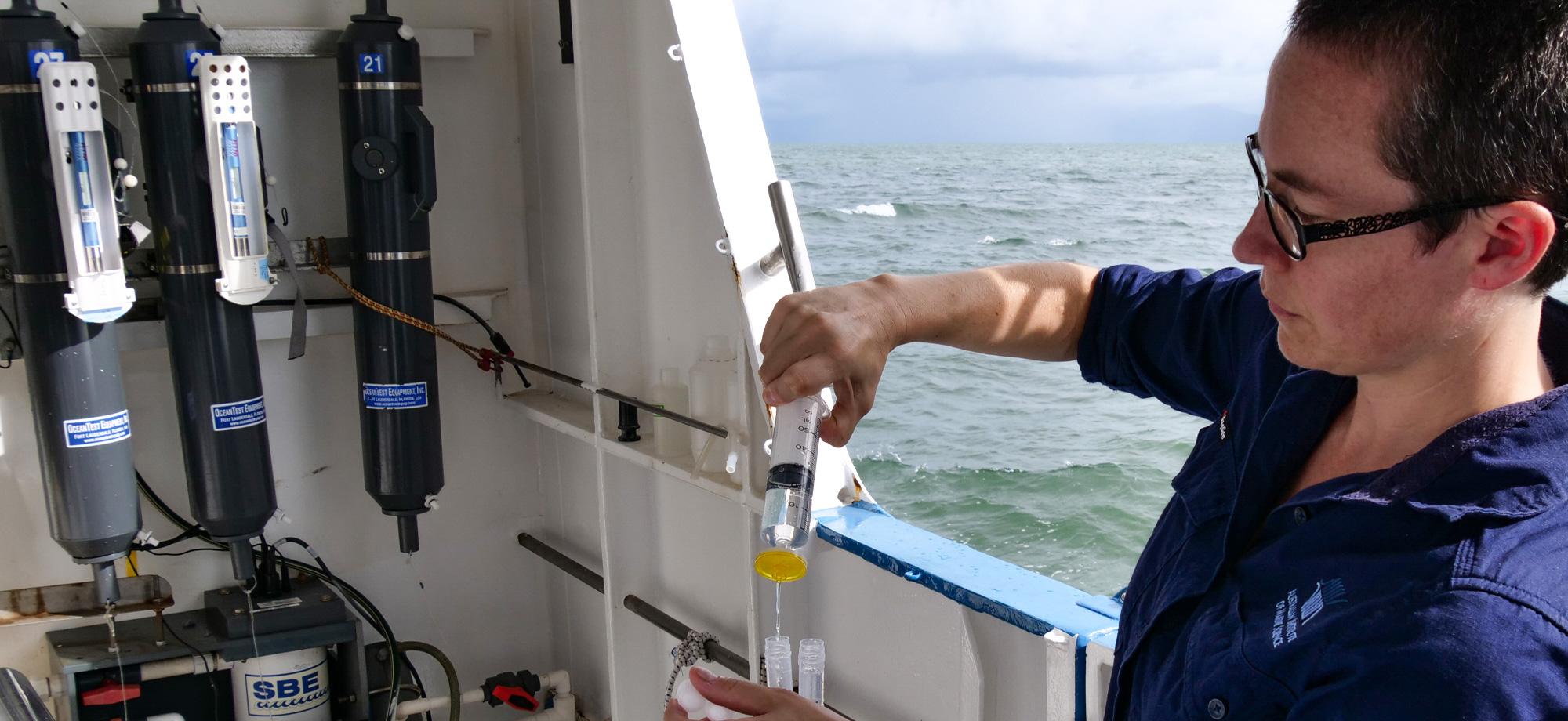 scientist on boat filtering water sample
