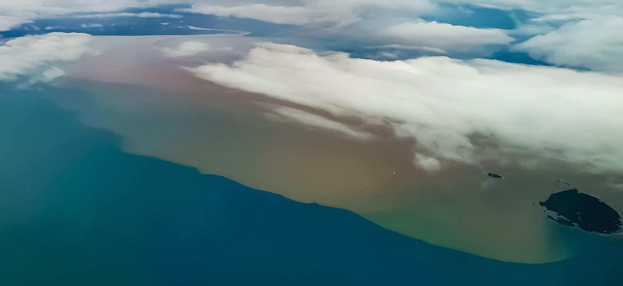 aerial of water with a brown flood plume