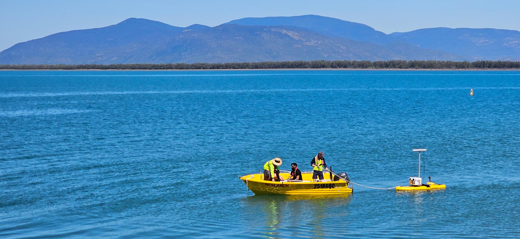 small research vessel tows a surfboard setup with autonomous systems