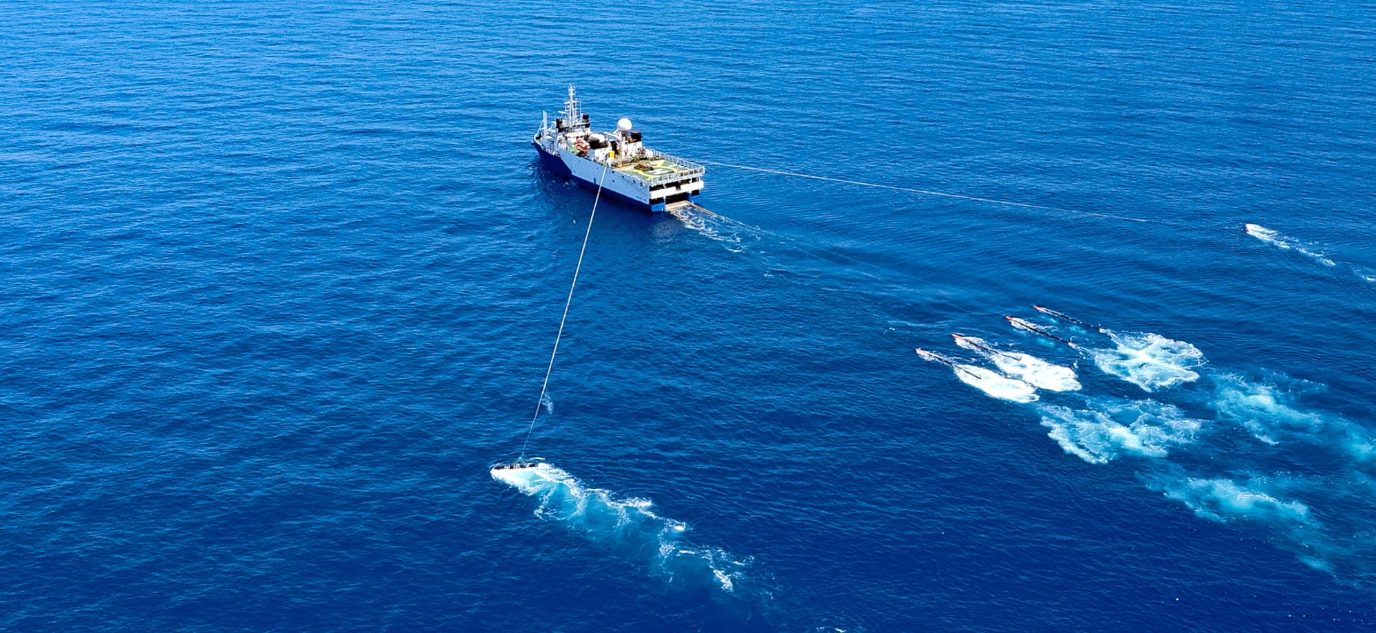 A ship tows research equipment