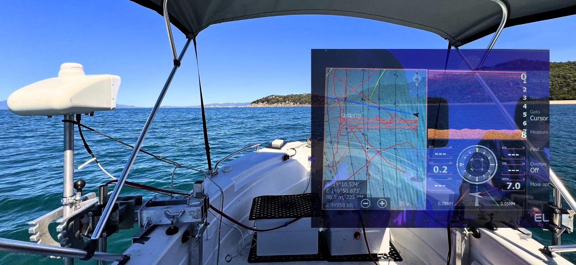 Composite image of the robotics hardware on a boat, overlaid with on-screen data outputs