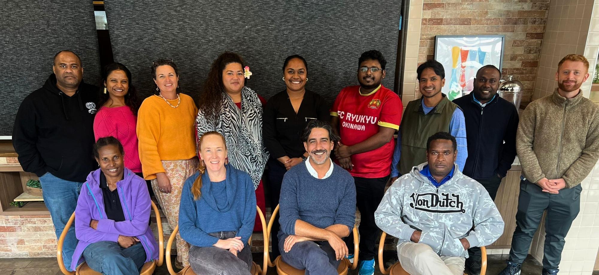 People posing for a group photo in a classroom