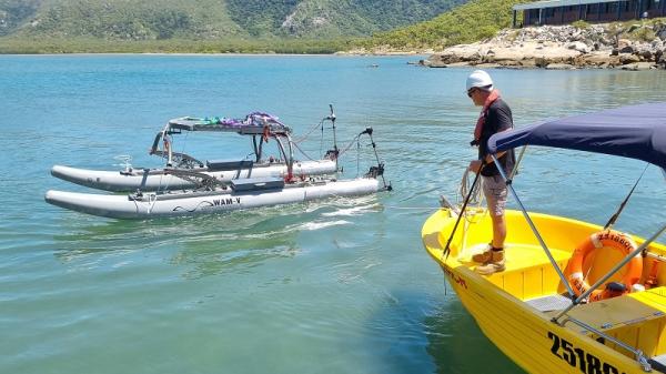 Autonomous surface vessel on water with Mt Cleveland behind