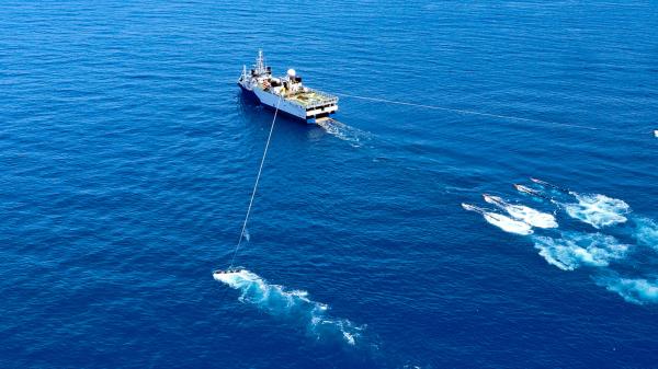 A ship tows research equipment