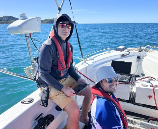 Engineers on a boat testing robotics hardware