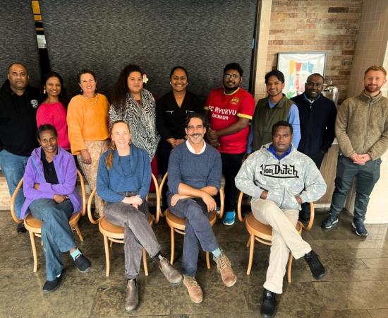 People posing for photo in classroom