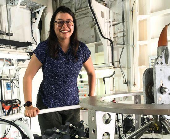 Oceanographer Dr Jessica Benthuysen on a research vessel next to ocean measuring equipment