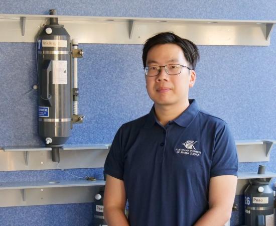 Scientist in front of niskin bottles