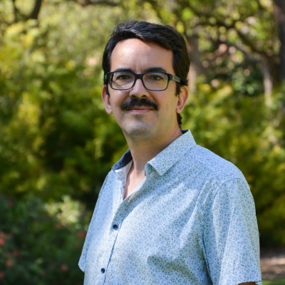 Gael standing outside facing the camera, wearing a light blue shirt.
