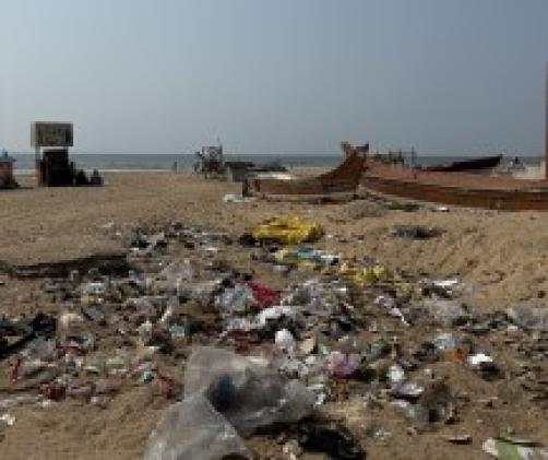 a beach with boats and litter